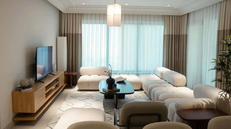 Modern luxury living room with elegant beige furniture, large windows, and natural lighting — aspirational lifestyle concept