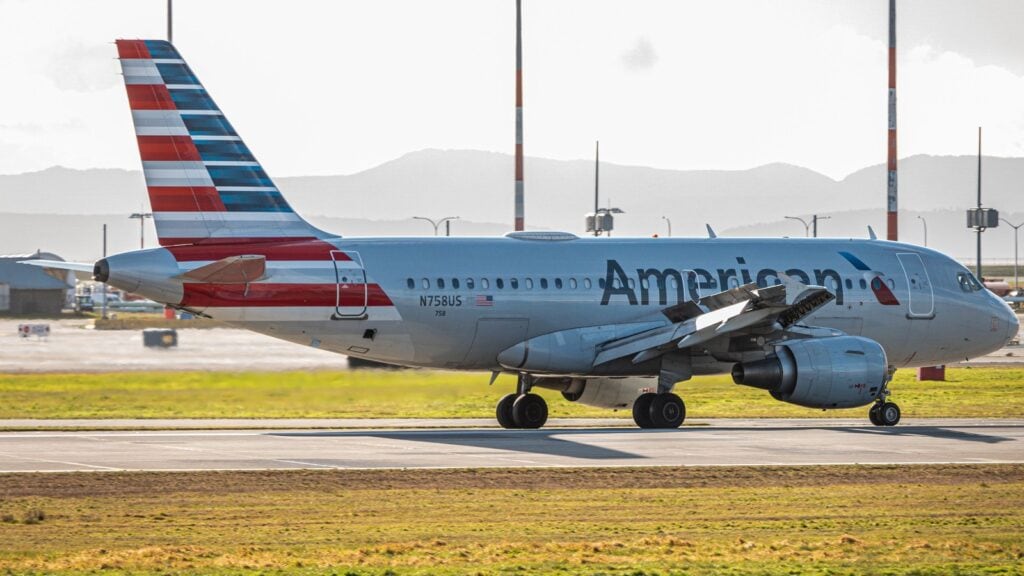 滑走路を走行するAmerican Airlinesの旅客機。尾翼に赤・白・青のフラッグ、機体側面に American のロゴが見える
